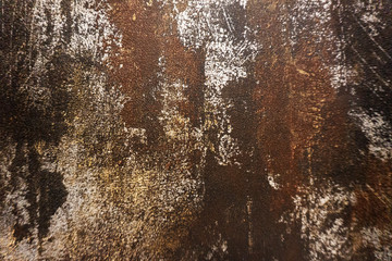 Dark black and brown background texture of a wallpaper with rusty stain and metallic pattern.