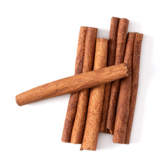 Cinnamon sticks isolated on white background closeup. Canella spice. Aromatic condiment background. Flat lay, top view.