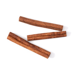 Cinnamon sticks isolated on white background closeup. Canella spice. Aromatic condiment background. Flat lay, top view.
