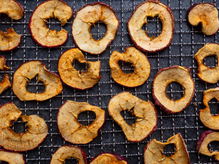 Dried slices of red and yellow dehydrated apples