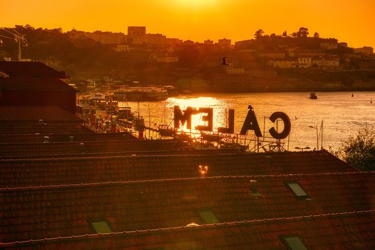 Porto, Portugal - September 7, 2019: View of the waterfront and the old city of Vila Nova de Gaia, Portugal. The famous Calem wine lodge, museum, cellars and taste of local port wine.