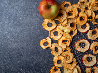 Dried slices of red and yellow apples, and fresh apple, rich in fiber and iron, healthy snack