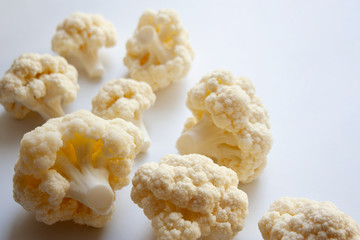 White cauliflower pieces isolated on white background close up