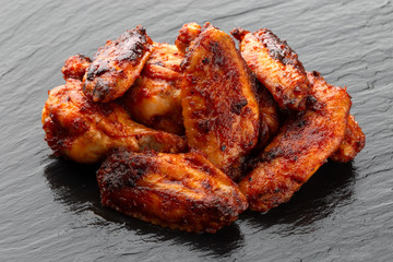 Fried wings close-up. Buffalo wings on a slate surface.