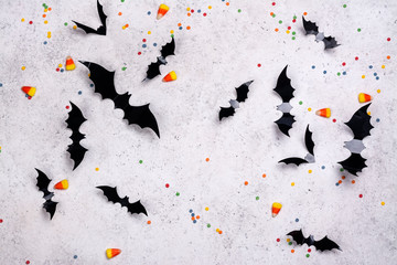 Black paper bats on a stone wall