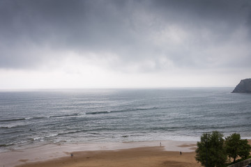 View of the beach on a rainy summer afternoon in Comillas, Spain, Europe