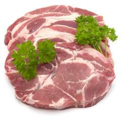 Raw pork neck chop meat with parsley herb leaves garnish isolated on white background cutout