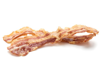 cooked crispy slices of bacon isolated on white background
