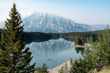 Calm body of water surrounded by tree during daytime