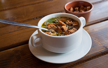 Soup with crackers. Chicken broth with crackers and herbs.