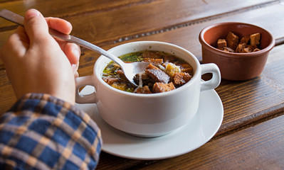 Soup with crackers. Chicken broth with crackers and herbs.