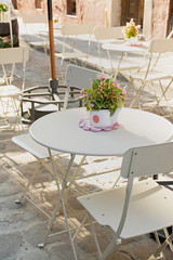 Summer table in a cafe on the summer terrace. White wooden table.