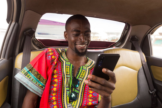 Man checking phone in a taxi