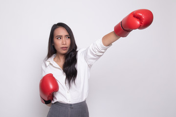 Young Asian woman with red boxing gloves.