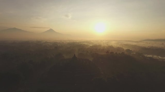 Aerial view 4K of Borobudur Temple in a misty surreal morning 