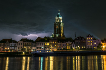 Obraz premium Night image of lightning over a river and historic city of Deventer, the Netherlands