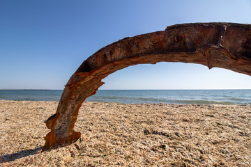 Installation with picturesque colored rusty iron on the beach. Krapets, the Black Sea coast, Bulgaria.