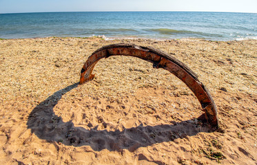 Heart on the beach. Installation with colorful colored rust iron and its shade. Krapets, the Black Sea coast, Bulgaria.