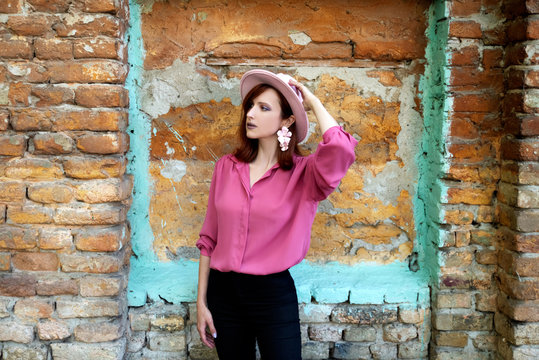 Woman in pink shirt and pink hat outdoors