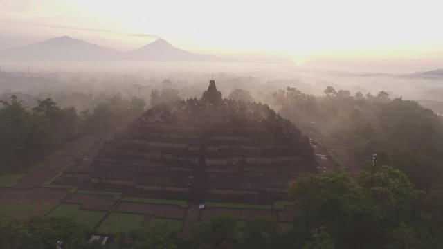 Aerial view 4K of Borobudur Temple in a misty surreal morning 