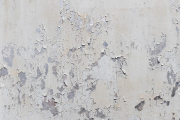 Grunge white metal wall with peeling paint, close-up background photo texture