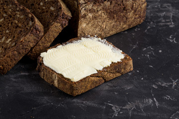 Rye bread on dark board background