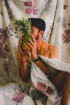 Man holding pineapple fruit