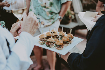 Man serves burger sliders