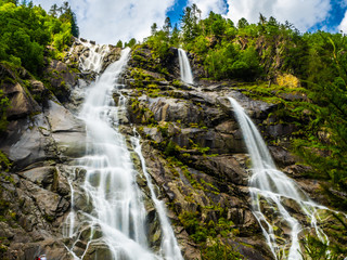 Fototapeta premium Nardis waterfall in the Adamello Brenta Dolomites park during an outdoor excursion, on a summer day