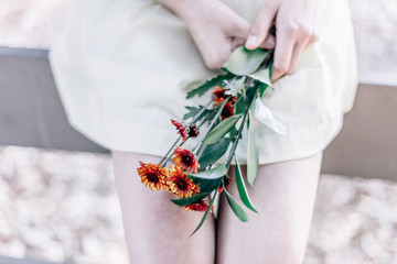 Person holding orange petaled flowers