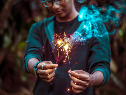Person holding sparklers in both hands