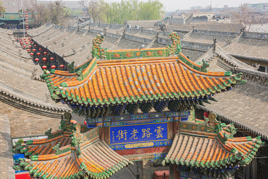 A colored tiled roof of a city gate in Pingyao seen from the city wall