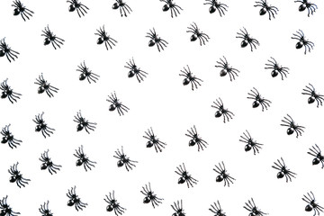 Black spiders on a white background. Halloween celebration background.