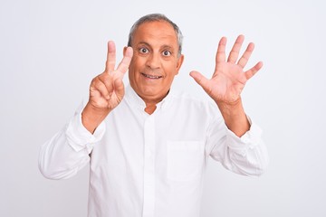 Senior grey-haired man wearing elegant shirt standing over isolated white background showing and pointing up with fingers number seven while smiling confident and happy.