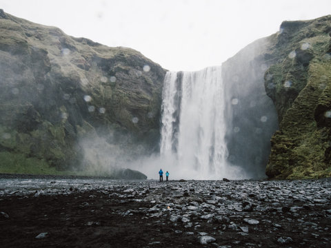 Person standing in front of waterfalls