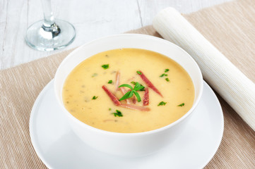 Yellow split pea cream soup with bacon and basil.
