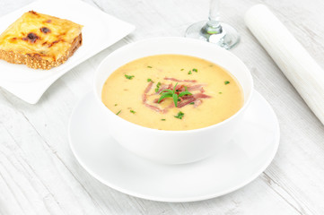 Yellow split pea cream soup with bacon and basil.