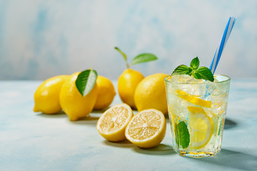 Freshly made lemonade  on a light background, cold refreshing drink .