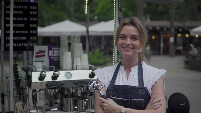 Beautiful barista woman during work in her movable street coffee shop
