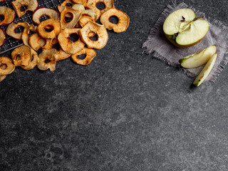 fresh applewith pieces of dry in dehydrator slices of yellow and red apples, healthy snack, copy space