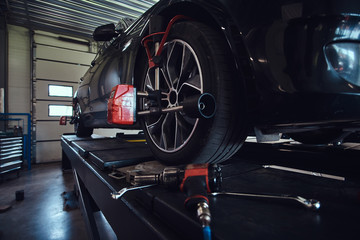 Closeup photo shoot of process or tyre balancing at dark auto service. © Fxquadro