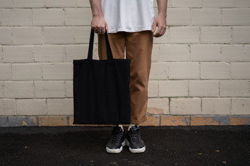 Fototapeta Man holding cotton Black Tote bag obraz