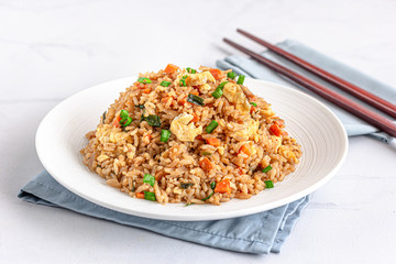 Chinese / Asian Egg and Vegetable Fried Rice on a White Plate on the White Background Photo.......