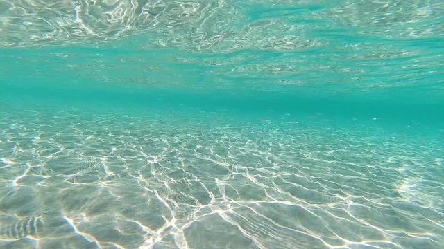 Underwater slow motion video of turquoise exotic open ocean sea bed in Caribbean sandy island beach
