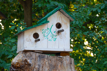 Wooden birdhouse on tree. Wooden birdhouse on the tree in public park, close up