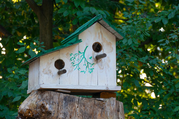 Wooden birdhouse on tree. Wooden birdhouse on the tree in public park, close up