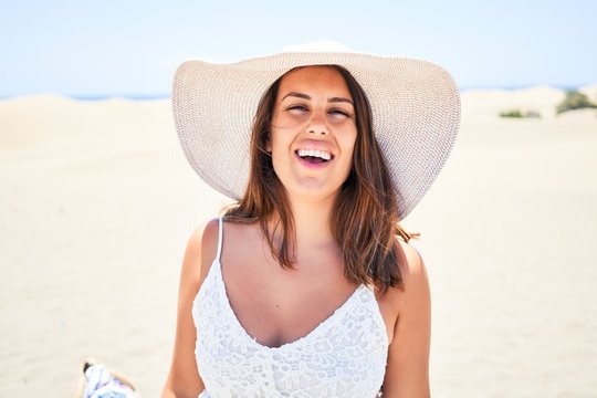 Young beautiful woman smiling happy enjoying summer vacation at maspalomas dunes beach