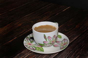 Cup of hot latte coffee on a dark wooden table, selective focus ,.