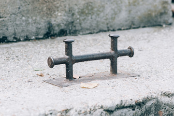 Old rusty bollard in the harbor