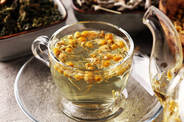 tea with Chamomile, sage and stinging nettle tea. Dried chamomile tea on table